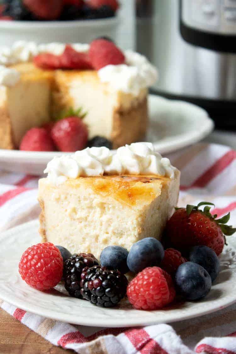 creme brulee cheesecake with berries on white plate