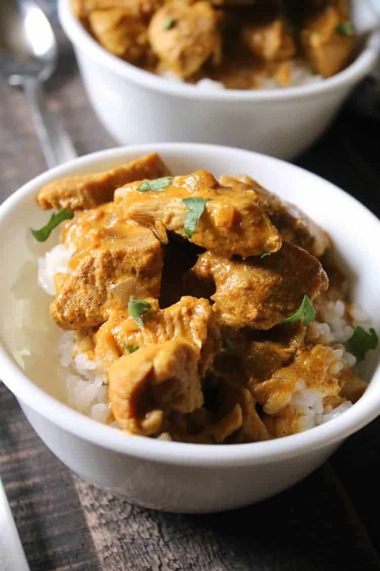 chicken curry with white rice in white bowl