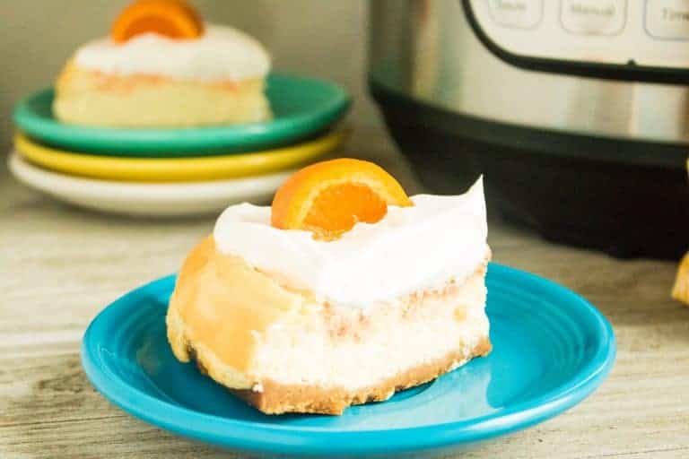 orange creamsicle cheesecake on blue plate