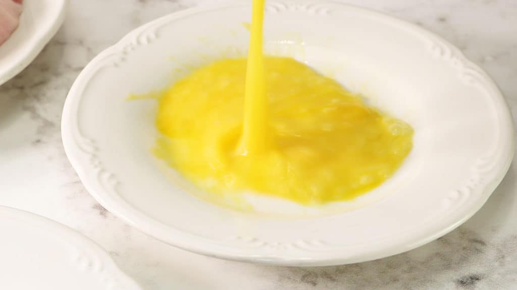 Beat egg in a bowl or on a shallow plate.