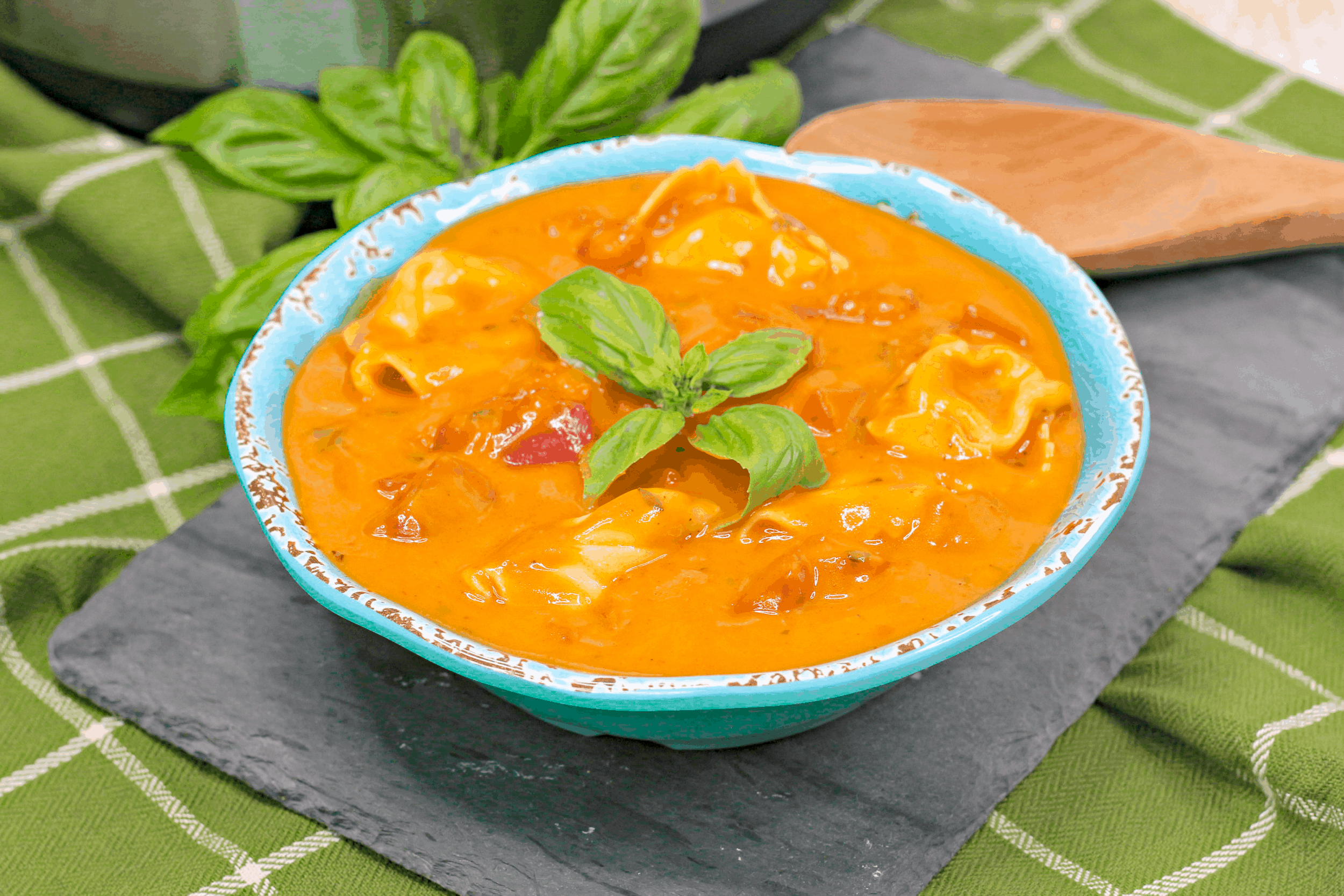tomato basil tortellini soup in blue bowl
