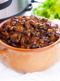 bowl of chili in front of a pressure cooker