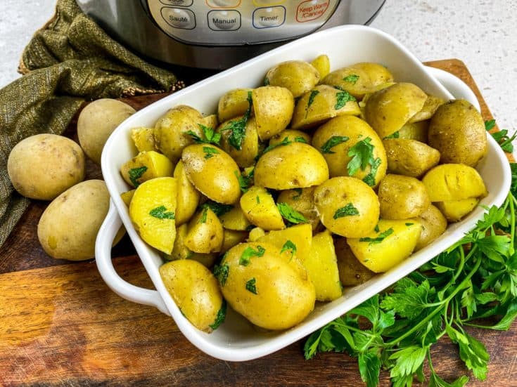 butter parsley potatoes in white serving dish