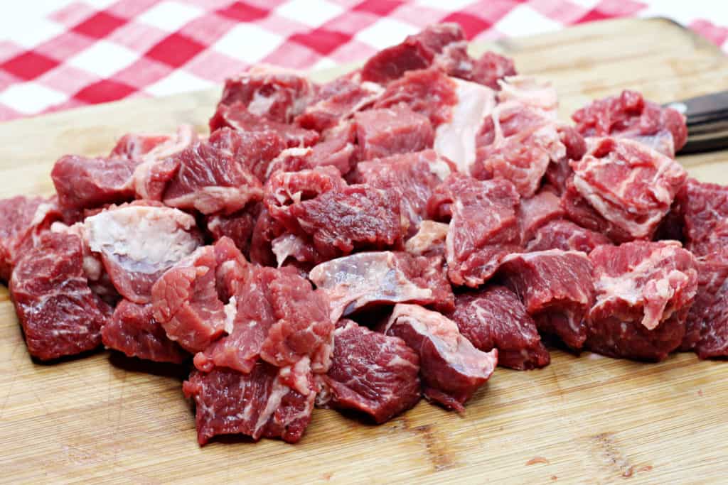 cut stew meat on cutting board